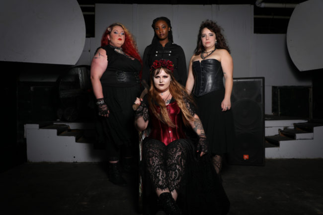 The cast of Lizzie with Guerrilla Theatre Front with Parker Bailey Steven (seated center) as Lizzie Borden and Siobhan Beckett (left) as Bridget, JacQuan Knox (center) as Alice, and Caitlin Weaver (right) as Emma Borden. Photo: Shealyn Jae Photography