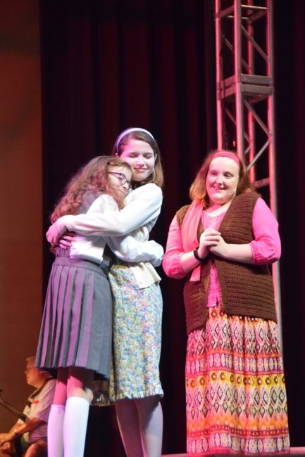 Maeve Acerno (left) as Matilda with Emily Signor (center) as Miss Honey and Mara Jade Beaumier (right) as Mrs. Phelps in Matilda at CPM