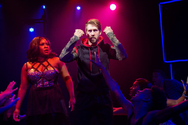 Ashley Johnson-Moore (left) as Rachel Marron and Justin Calhoun (right) as The Stalker in The Bodyguard. Photo: Jeri Tidwell.