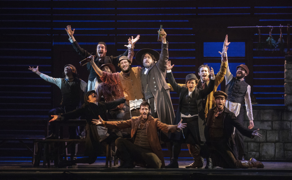 Yehezkel Lazarov (center left) as Tevye, and Jonathan Von Mering (center right) as Lazar Wolf & the Cast of Fiddler on the Roof. Photo: Joan Marcus