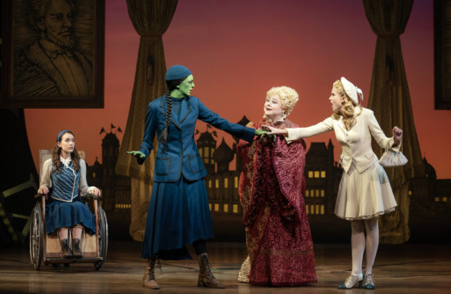 L to R: Amanda Fallon Smith as Nessarose, Talia Suskauer as Elphaba, Sharon Sachs as Madame Morrible, and Allison Bailey as Glinda in Wicked. Photo: Joan Marcus.