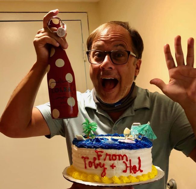 Celebrating his 52nd Birthday- Mark Minnick and a cake. And a bottle.