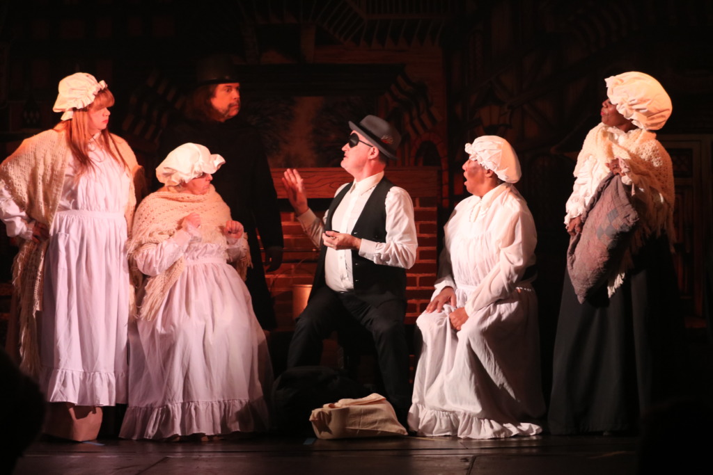 (L to R) Jane Collins as Cook, Barbara Reichert as Laundress, Tom Delaney as Old Joe, Kathy McBee as Charwoman, and Lena Jackson as Mrs. Dilber in A Christmas Carol. Photo: Kathleen Swain