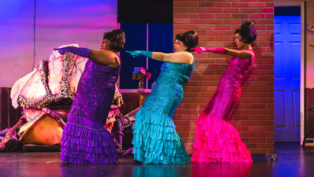 Tigga Smaller (left) as Crystal, Kalea Bray (center) as Ronette, and Isabel Bray (right) as Chiffon in Little Shop of Horrors. Photo: Matthew Peterson.