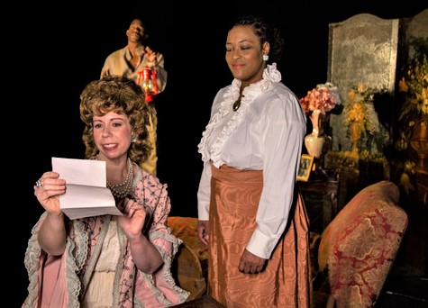 Laura Weiss (left) as Mrs. Van Buren, with Ryan Holmes (background) as George Armstrong, and Takira Thompson (right) as Esther. 