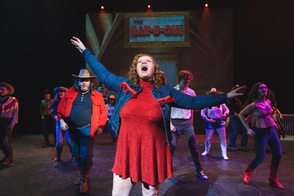 Mia Coulbourne (center) as Rusty and the cast of Footloose. Photo: Matthew Peterson