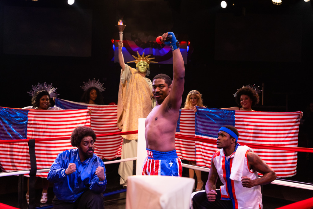 Gerard Jordan (center) as Apollo Creed and the company of Rocky at Toby's Dinner Theatre. 📸 Jeri Tidwell Photography