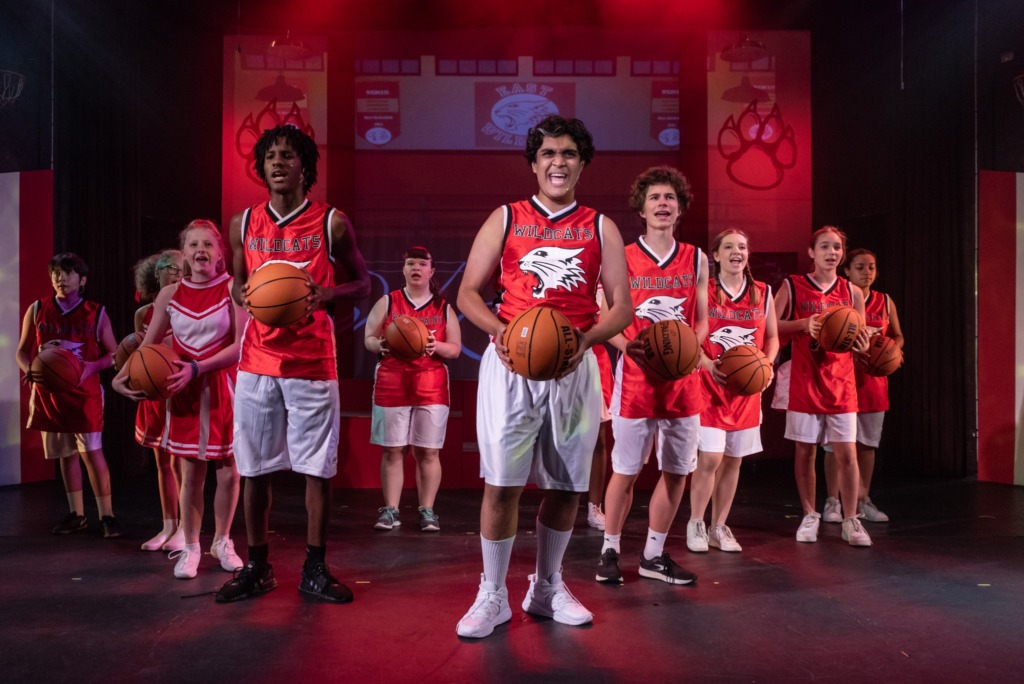 Jordan Dixon (center left) as Zeke with Shameer Mirza (dead center) as Troy and Jackson Foard (center right) as Chad and the cast of High School Musical 📸THsquared Photography