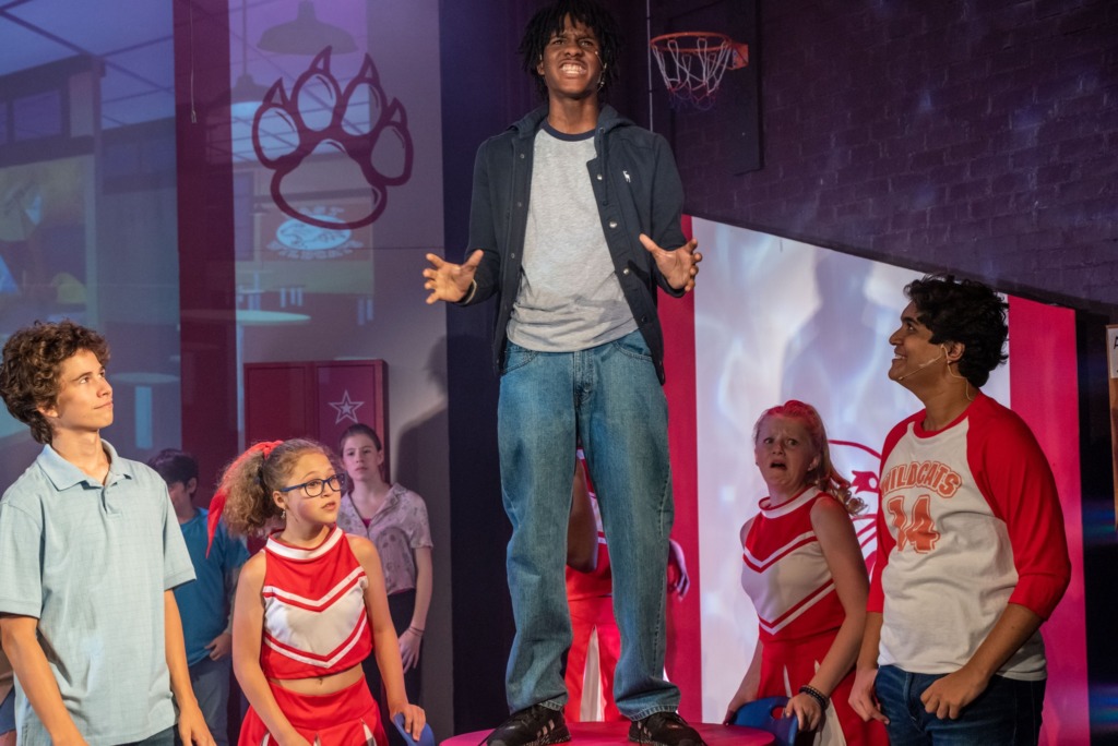 Jordan Dixon (center) as Zeke and the cast of High School Musical📸THsquared Photography
