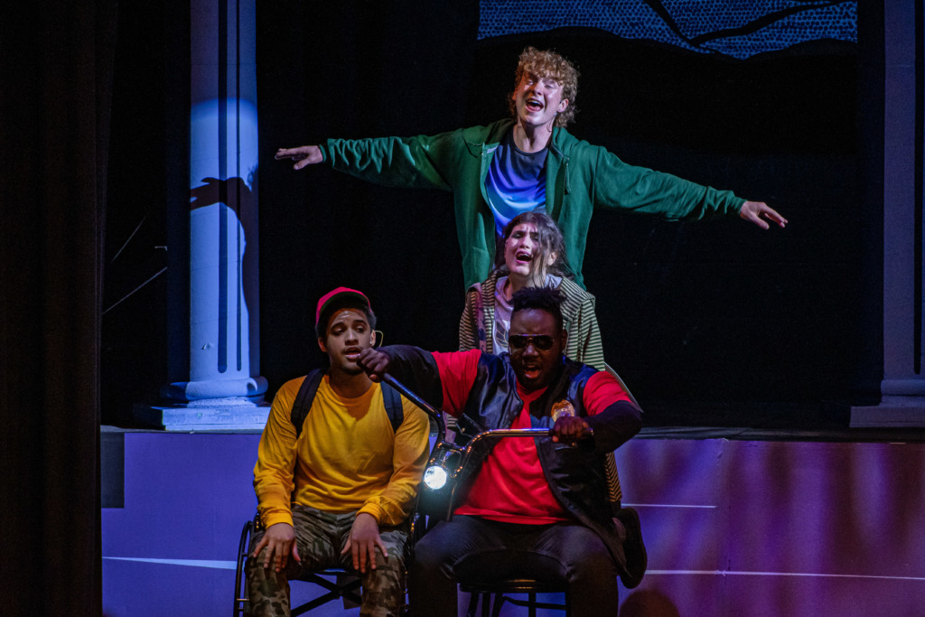 Reid Murphy (above) as Percy Jackson with Nick Thompson (left) as Grover, Leah Freeman (center) as Annabeth, and Otega Okurume (right) as Ares in The Lightning Thief. 📸 Stasia Stewart Photography