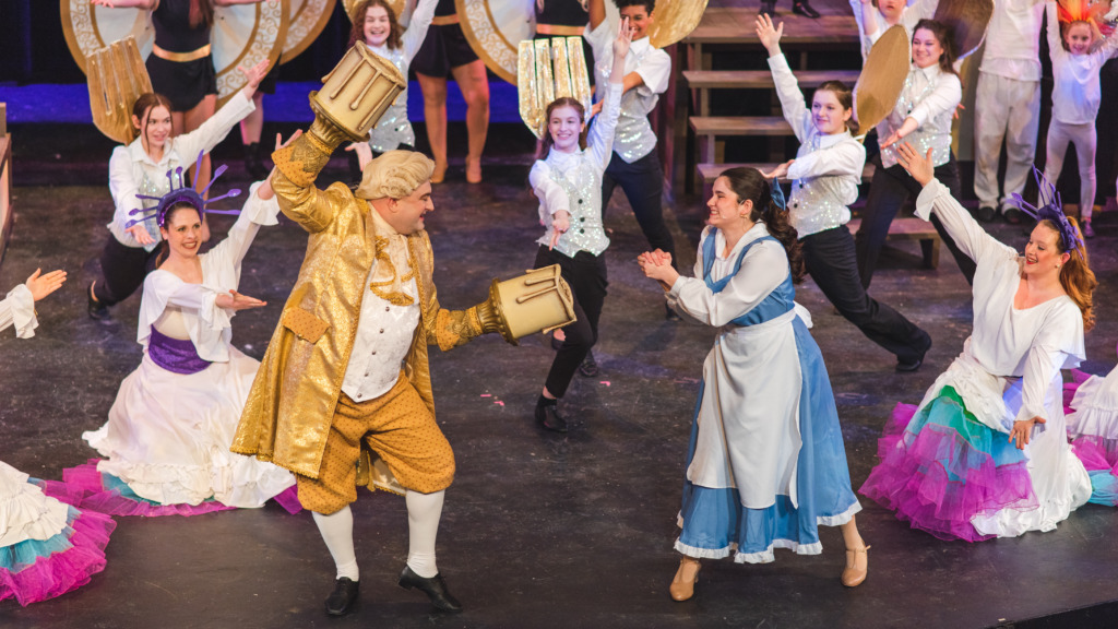 Joseph Murphy (left) as Lumiere and Jess Simonson (right) as Belle with the cast of Beauty & The Beast 📸Matthew Peterson