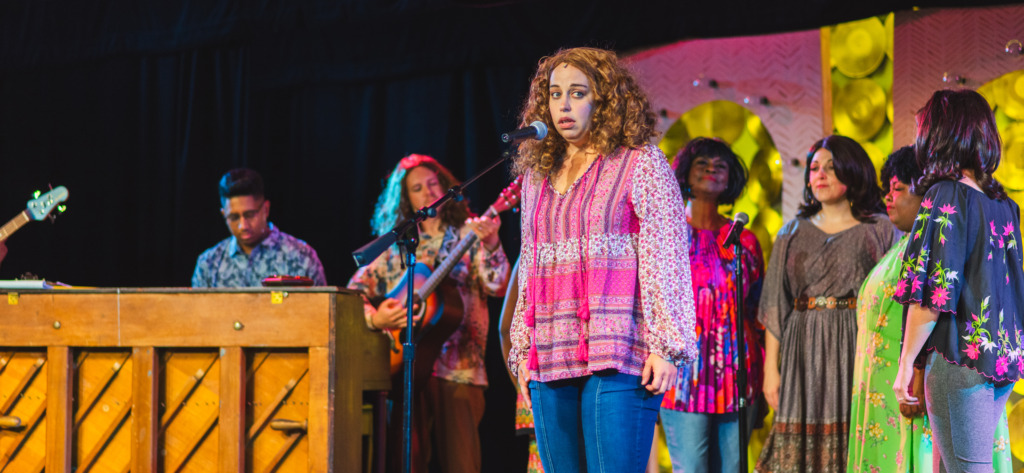 Julie Parrish (center) as Carole King and the ensemble of Beautiful at Tidewater Players. 📸Matthew Peterson