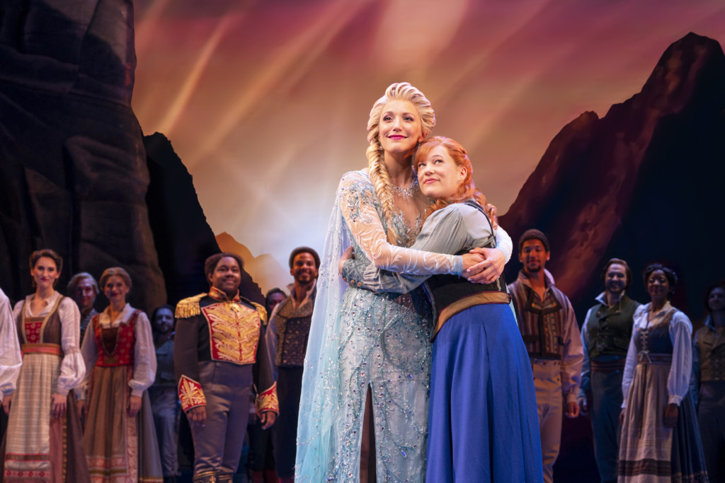 Caroline Bowman (left) as Elsa and Lauren Nicole Chapman (right) as Anna and the cast of Disney's Frozen, North American Tour. 📷 Deen van Meter