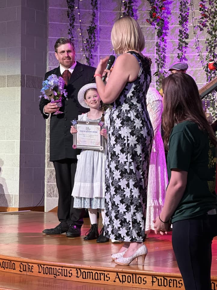 Amanda Gunther (right) presenting a Theatre Bloomie Award for the achievement of outstanding excellence in a theatrical production to David Merrill (left) and Grace Gavin (center) on behalf of The Secret Garden at Woods Memorial Presbyterian Church