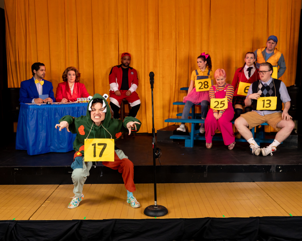 (L-R) Omar A. Said (Panch), Beth Amann (Rona Lisa), B.J. Robertson (Mitch), Taylor Litofsky (Logainne), Cera Baker (Marcy), Preston Grover (Chip), Sam Slottow (Leaf), Lila Cooper (Olive), and Stephen Emery (Barfée) in The 25th Annual Putnam County Spelling Bee, presented by Compass Rose Theater 📷