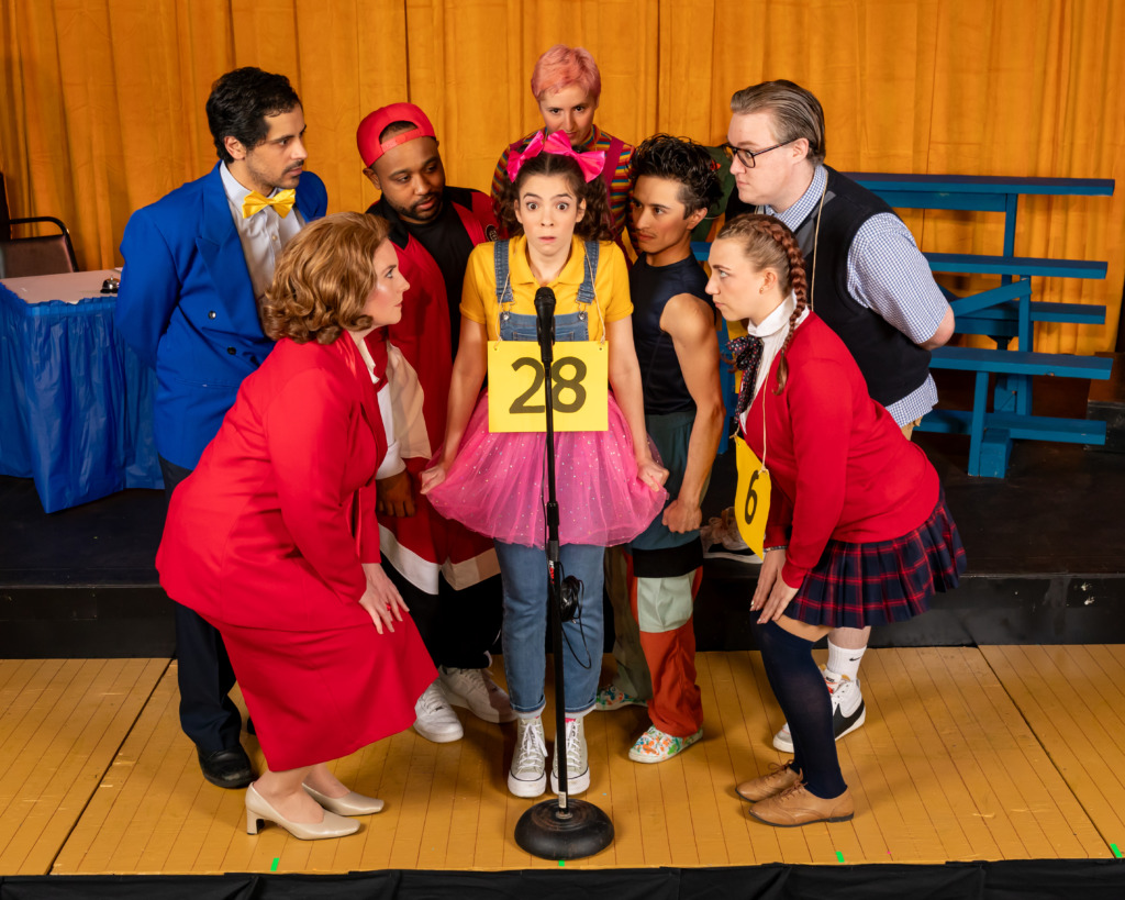 (L-R) Omar A. Said (Panch), B.J. Robertson (Mitch), Lila Cooper (Olive), Stephen Emery (Barfée),
Beth Amann (Rona Lisa), Taylor Litofsky (Logainne), Sam Slottow (Leaf), and Cera Baker (Marcy) in The 25th Annual Putnam County Spelling Bee, presented by Compass Rose Theater  📷 Joshua Hubbell
