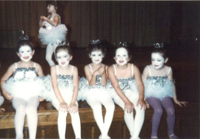 Kelly Rardon (second from left, hands on knees) in a ballet recital age 7 or 8 years old.