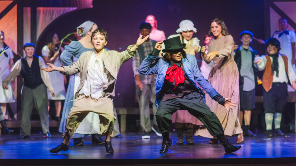 Colton Roberts (left) as Oliver with Maxton Folmer (right) as The Artful Dodger and the company of Oliver! at Tidewater Players 📷 Matthew Peterson