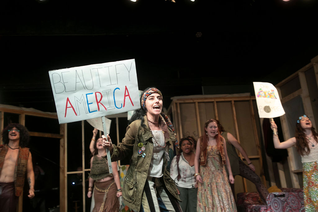 Sheila (center, played by Ege Yalcinbas) leads 'The Tribe' in protest in Hair at Vagabond Players 📷 Shealyn Jae Photography