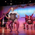 Eric Jones (center) as Frank-N-Furter in The Rocky Horror Show at MET & FCC