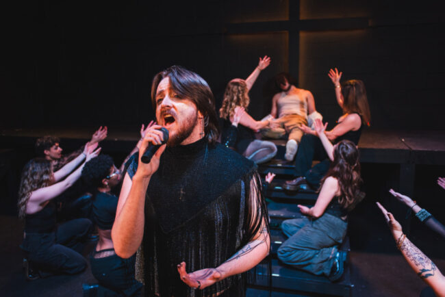Jacob Gross (center) as Judas and the cast of Jesus Christ Superstar at Street Lamp Community Theatre 📷 Machpe Photography