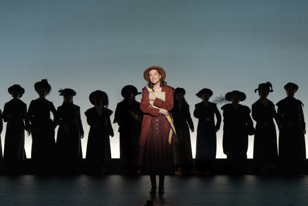 Maya Keleher (center) as Alice Paul in the First National Tour of Suffs 📷 Joan Marcus