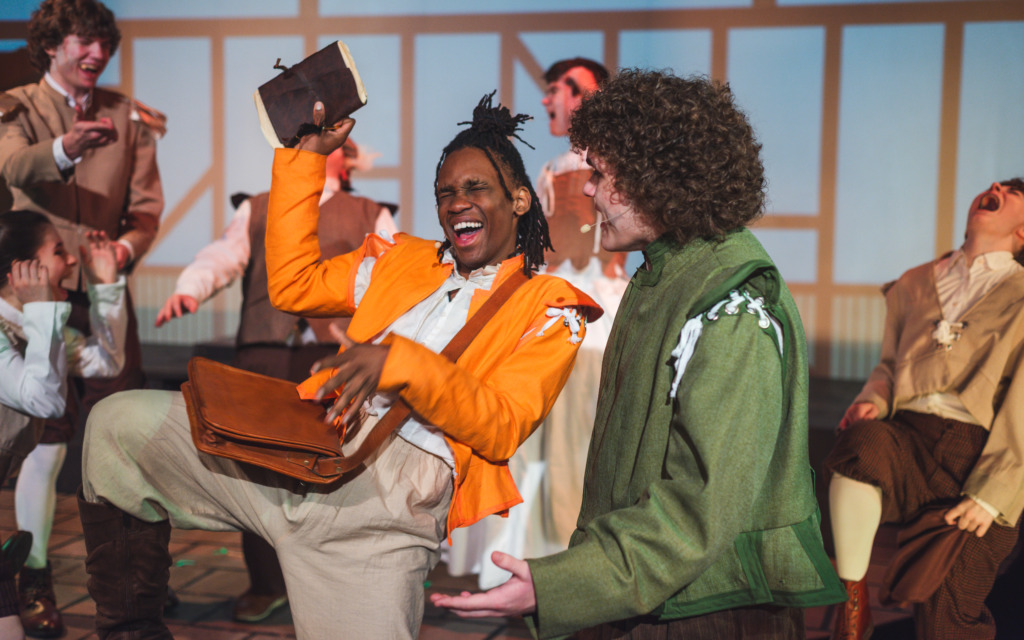 Alphan Nthuo (left) as Nigel Bottom and Viktor Wilson (right) as Nick Bottom and the company of Something Rotten! at Theatreworks Live 📷Matthew Peterson