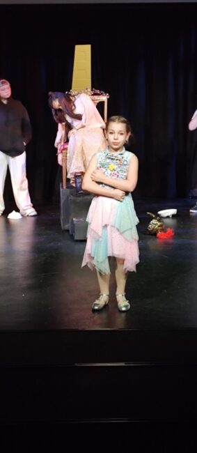 Claire McDaniel (foreground) as Page and Juliette Ladelma (enthroned) as Thea in Live Theatre at Apex Arts.
