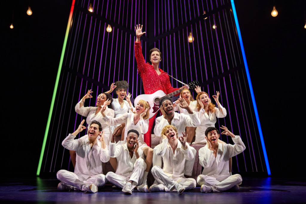 Nick Fradiani (center) as Neil 'Then' and the company of A Beautiful Noise: The Neil Diamond Musical 📷 Jeremy Daniel